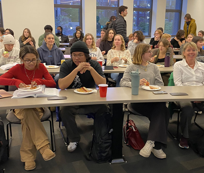 Students enjoying pizza during the 2024 Philosophy Faculty Debate